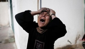 The mother of one of the four Palestinian children from the Baker family, whom medics said were killed by a shell fired by an Israeli naval gunboat, grieves outside the morgue in Gaza City