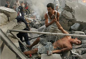 “TYRE, LEBANON. WEDNESDAY, JULY 26, 2006: Israeli aircraft struck and destroyed two buildings in downtown Tyre, Lebanon Wednesday evening. As people searched through the burning remains, aircraft again could be heard overhead, panicking the people that a second strike was coming. This man fell and was injured in the panic to flee the scene. He is helped by another man, and carried to an ambulance. (Photo: Tyler Hicks/The New York Times)”