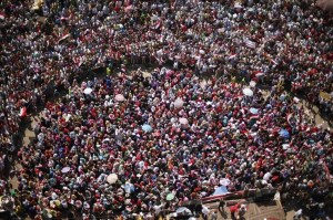 Tahrir Square, Cairo 2013. Men form a protective circle around women demonstrators