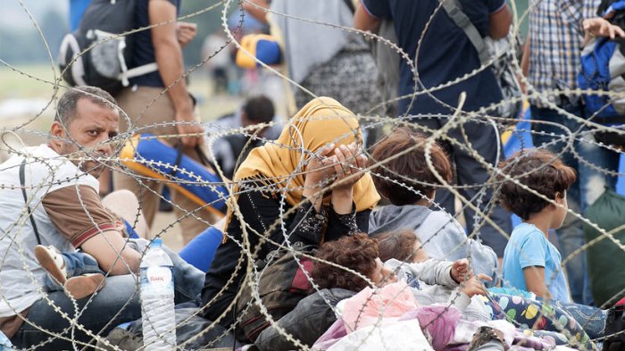 Refugees wait at the Macedonian-Greek border near the town of Gevgelija, on August 22, 2015. Some 2,000 mostly-Syrian refugees spent a rainy night stranded in no-man's land between Greece and Macedonia as hundreds more began arriving on August 22, on their way to western Europe. The refugees and migrants, who have been there since August 20 spent the night sleeping on the ground despite heavy rain and temperatures which fell sharply during the night. Army troops were deployed throughout the forested hills which line the 50-kilometre (30-mile) border, army spokesman colonel Mirce Gjorgoski told AFP, giving no further details.  ROBERT ATANASOVSKI/AFP/Getty Images